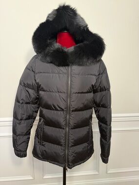 Prada 28A060 women's down puffer jacket in black, featuring a fur hood. New.